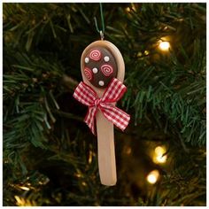 a wooden spoon ornament hanging from a christmas tree