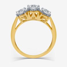 three stone diamond ring in yellow gold with diamonds on the shoulders and sides, set against a white background