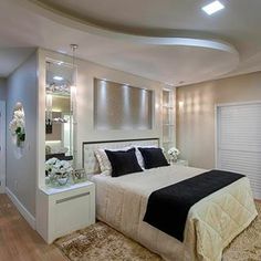 a bedroom with a bed, dresser and mirror on the wall next to an open closet