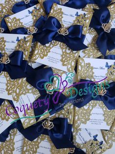 many blue and gold wedding cards with ribbons on top of each other, all in different designs