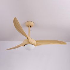 a ceiling fan with wooden blades and a white light