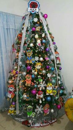 a decorated christmas tree in the corner of a room