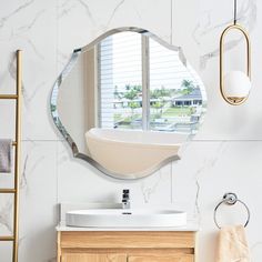 a bathroom with a sink, mirror and towel rack