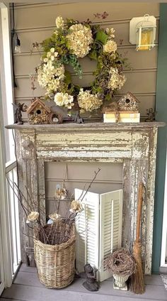 a fireplace mantel decorated with flowers and birdhouses