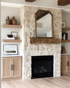 a living room with a fire place and wooden shelves on the wall, along with a large mirror above it