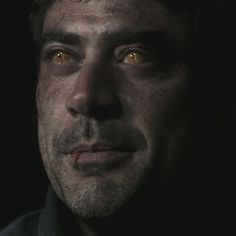 a man with yellow eyes looking at the camera