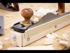 a wooden stamper sitting on top of a table next to some pieces of wood