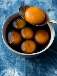 four eggs in a bowl with a spoon