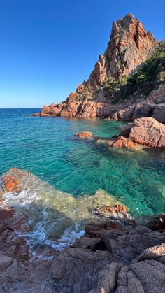 the water is crystal blue and green near some rocks