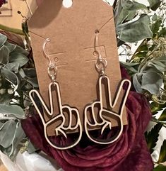 the earrings are made out of wood and have two fingers on them, as well as one