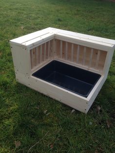 a dog house built into the grass