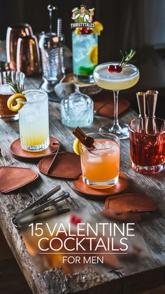 a wooden table topped with glasses filled with different types of cocktails and garnishes