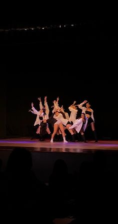 a group of people that are standing on a stage