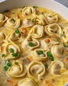 a white bowl filled with pasta and vegetables