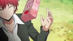 an anime character holding up a box with strawberries on it