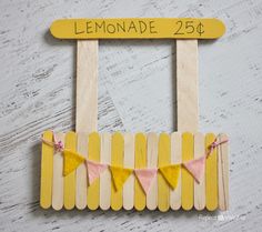 popsicle lemonade sign with clothes pins and bunting on the outside for decoration