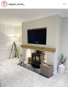 a living room with a fireplace, television and wicker basket