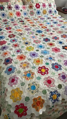 a bed with a colorful quilt on top of it