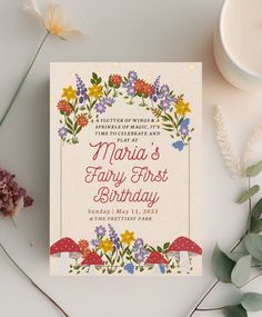 an image of a birthday card with flowers and mushrooms in the background on a table