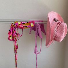 two hats are hanging on a clothes rack