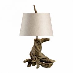 a lamp that is made out of driftwood and has a white shade on it