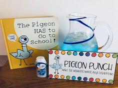 a wooden table topped with books and glasses filled with blue liquid next to a sign