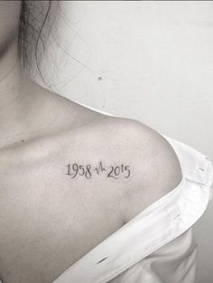 a woman with a tattoo on her shoulder that reads, born in may 1989 and has the date tattooed