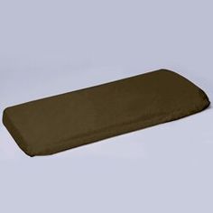 a brown pillow sitting on top of a white table