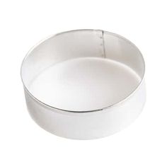 an empty white cake pan on a white background