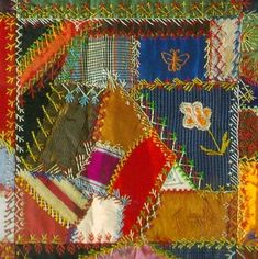 a close up of a patchwork quilt with many different colors and designs on it