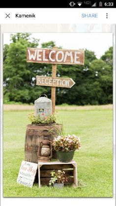 a wooden sign that says welcome to the reception area with potted plants on it