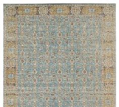 an area rug with blue, yellow and brown colors on the bottom half of it