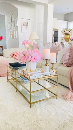 a living room filled with lots of furniture and flowers on top of a coffee table