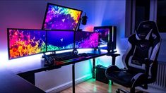 three computer monitors sitting on top of a desk