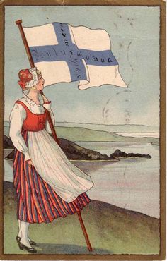 a woman holding a flag on top of a hill next to the ocean in front of an island