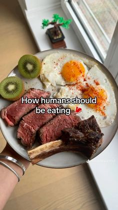 someone holding a plate with food on it that says, how humans should be eating