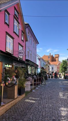 a cobblestone street lined with colorful buildings