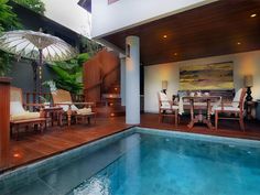 an indoor swimming pool surrounded by wooden decking