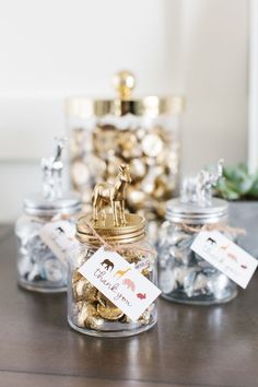 small glass jars filled with gold and silver candy