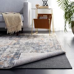 a living room with a couch and rug on the floor