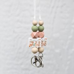 an ornament hanging from the side of a white wall with words on it