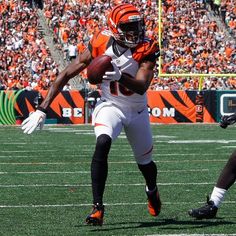 a football player is running with the ball