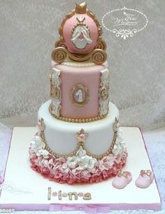 a pink and white cake with gold trimmings