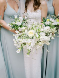 the bridesmaids are holding their bouquets with white and green flowers in them