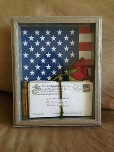 an american flag and two books in a shadow box on a couch with the caption's message