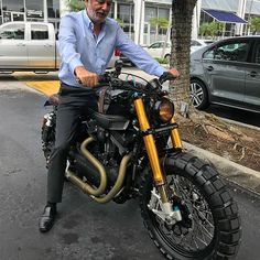 a man sitting on top of a motorcycle