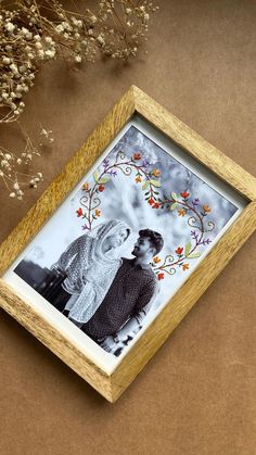 a wooden frame holds an image of two people