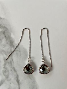 "Fine and delicate, these earrings flow from the earlobe in a beautiful silver line. Length can be adjusted depending how far the chain is pulled through the ear. These threader earrings measure 55mm in length. Hanging from one end of the chain is a beautiful faceted glass charm. Threader earrings come with wire ends to make it easy to thread the chain through any pierced hole of your ear, making these earrings fun to wear and play around with (from one pierced hole to another). Their versatilit Dainty Silver Threader Earrings For Party, Elegant Silver Threader Earrings For Gifts, Silver Sterling Threader Earrings For Party, Silver Sterling Silver Threader Earrings For Party, Silver Long Drop Threader Earrings For Party, Elegant Silver Long Drop Threader Earrings, Delicate Silver Linear Earrings With Ear Wire, Minimalist Gray Sterling Silver Jewelry, Adjustable Nickel-free Silver Threader Earrings