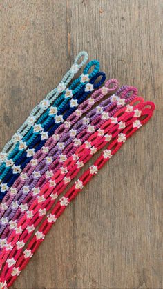 multicolored crocheted bracelets on wooden surface