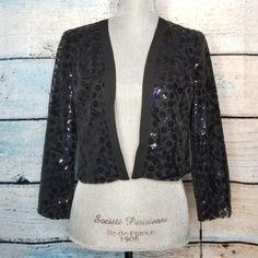 Small Black Open Front Cardigan With Black And Navy Floral Patterned Sequin Overlay. Cropped With 3/4 Sleeve Length. Fully Lined. New With Tags. Flat Lay Measurements: Approximately 16.5" Bust, 17" From Top Of Neck Collar To Hem Please Ask For Any Other Measurements Fitted Sequin Evening Cardigan, Fitted Chic Sequined Cardigan, Chic Fitted Sequin Cardigan, Spring Evening Fitted Cardigan, Fitted Sequin Chic Cardigan, Fitted V-neck Cardigan For Evening, Fitted Evening Cardigan For Spring, Fitted Open Front Cardigan For Party, Fitted Black Cardigan For Evening